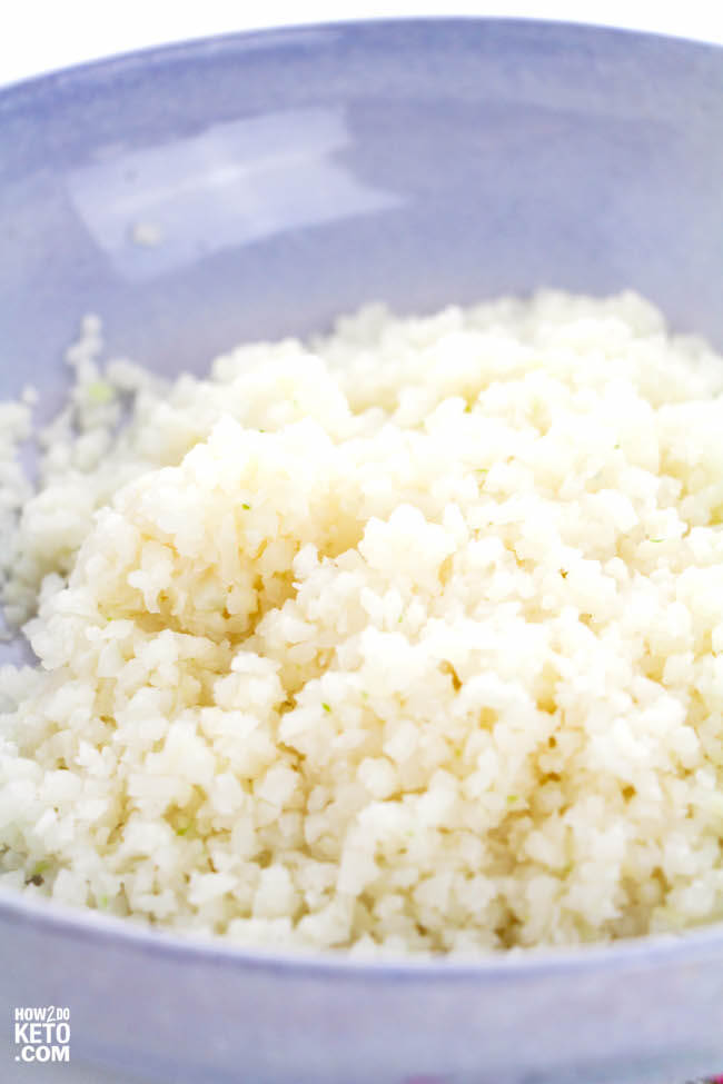 fluffy white keto cauliflower rice in blue bowl