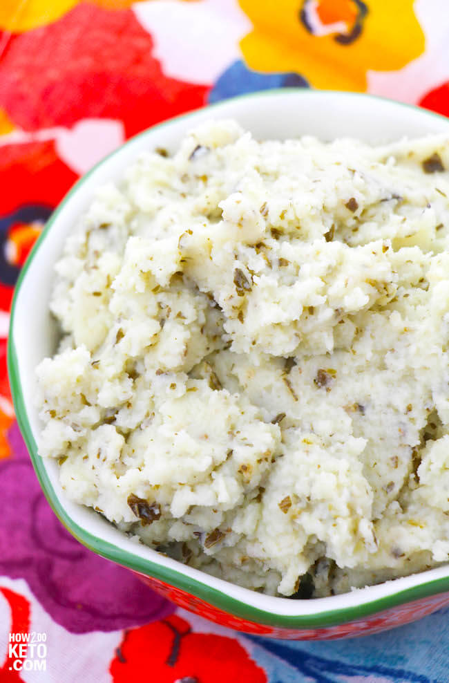 Flavorful pesto makes these Keto Cauliflower Mashed Potatoes a keeper...comfort food without all the carbs! You won't even miss the "real" thing!