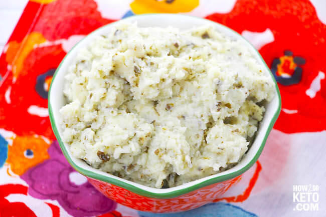 Flavorful pesto makes these Keto Cauliflower Mashed Potatoes a keeper...comfort food without all the carbs! You won't even miss the "real" thing!
