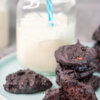 keto chocolate cookies on tray with a glass of milk