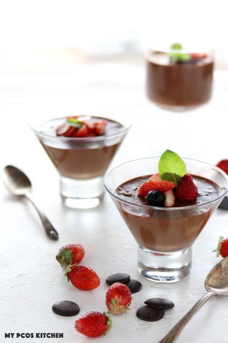 chocolate pudding topped with fruit in parfait glass