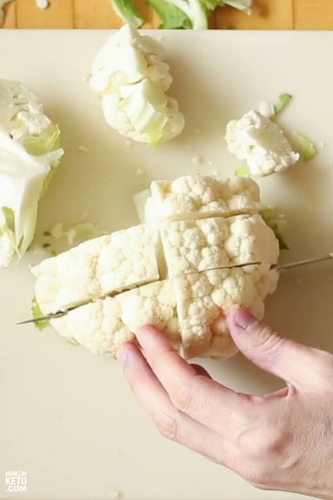 chopping fresh cauliflower into florets