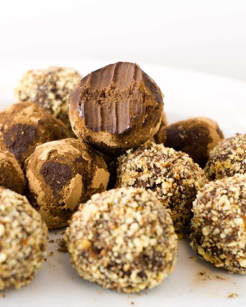 chocolate truffles with crushed almond coating, one with a bite taken