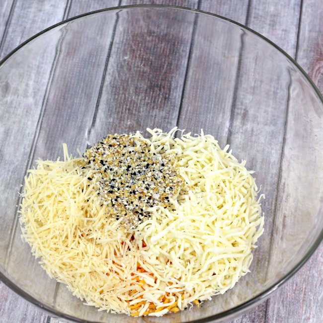 Shredded cheese in glass mixing bowl