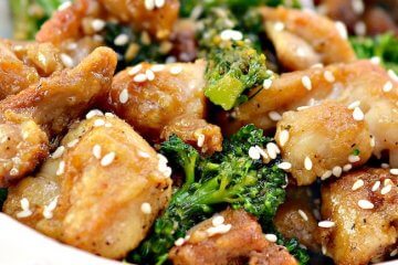 crispy sesame chicken in bowl with broccoli