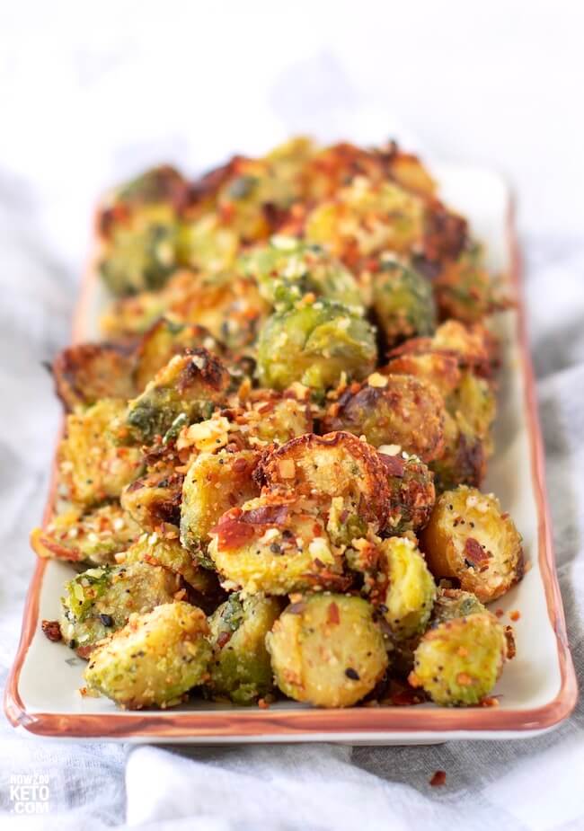 plate of crispy Brussel sprouts topped with parmesan and bacon