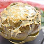 These keto-friendly stuffed artichokes are smothered in cheese and topped with crispy pork rind crumbles - they're so good they literally melt in your mouth!