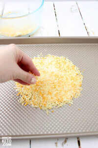 placing cheese on a circle on a baking sheet