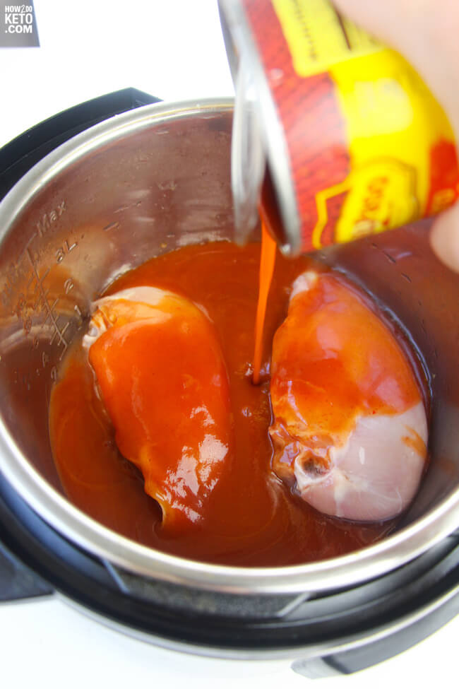 Adding enchilada sauce to Instant Pot with two chicken breasts