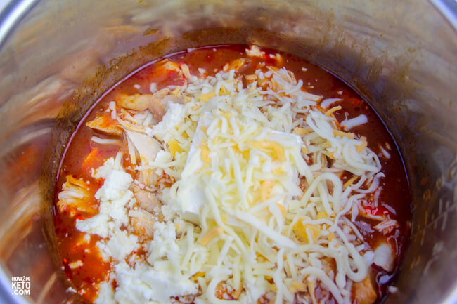 shredded chicken topped with cheese in Instant Pot