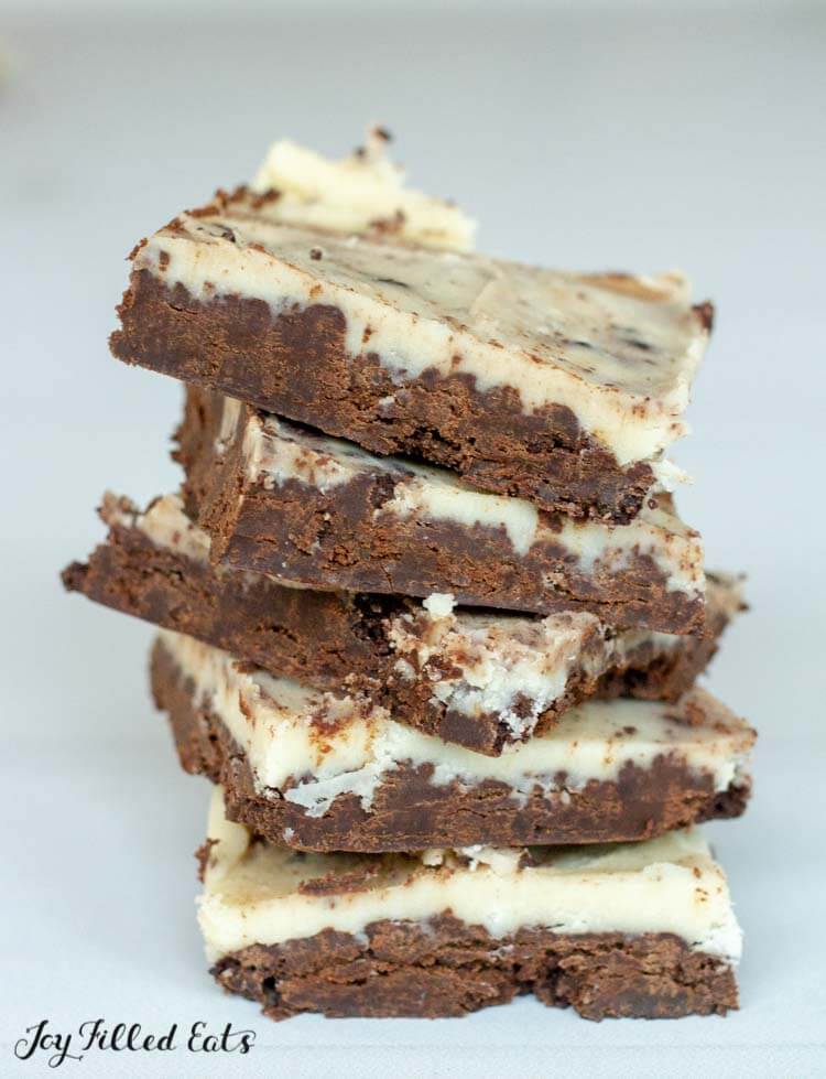 stack of keto brownies with white frosting