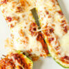 keto zucchini boats stuffed with meat, pizza sauce, and cheese