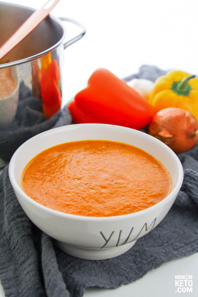 bowl of roasted red pepper soup with pepper and onion
