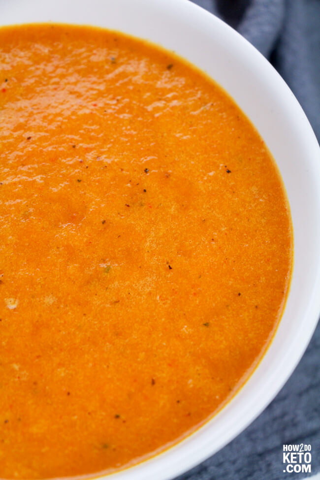 close up of a bowl of red pepper soup