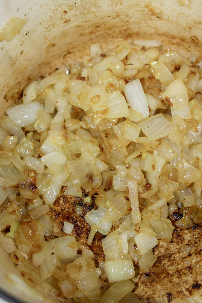cooking diced onions in a Dutch oven pot