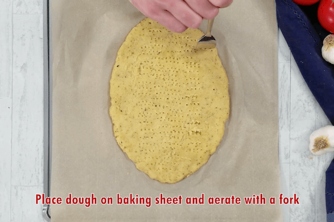 poking holes in keto pizza dough with fork