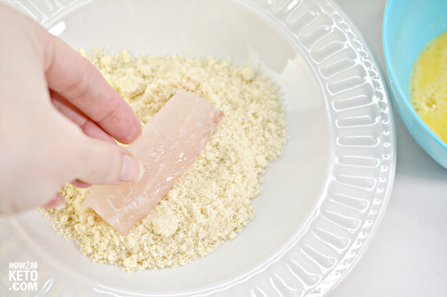 dipping fish sticks in almond flour coating