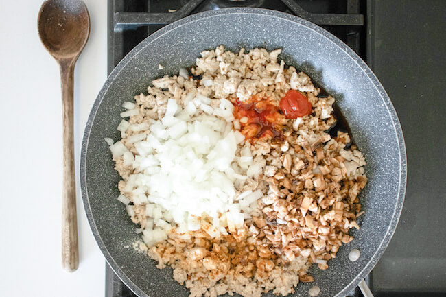 ground chicken, diced onions, and soyy sauce in sauté pan