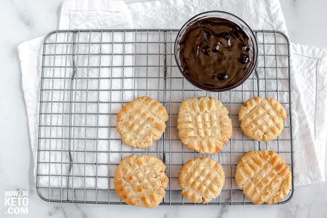 low carb butter cookies on wire rack with a bowl of chocolate