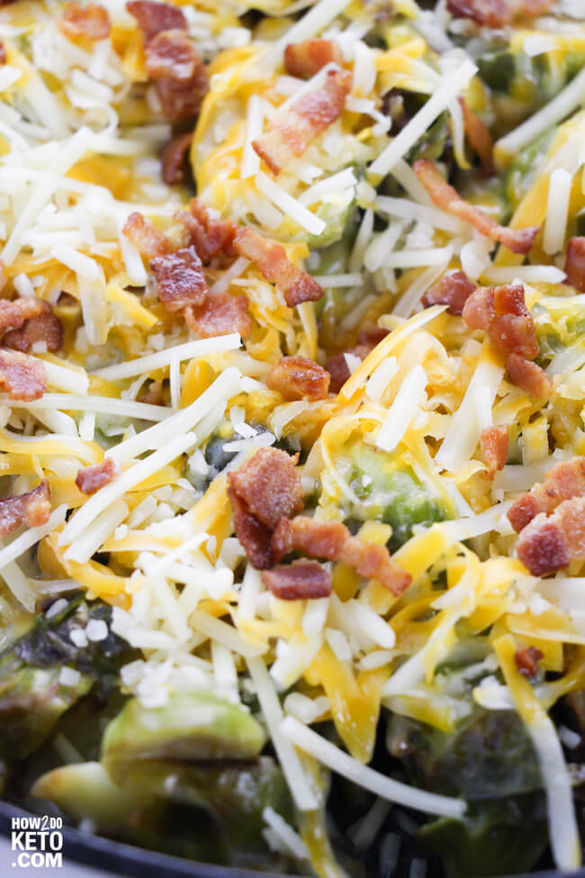 shredded cheese and bacon pieces on top of brussel sprouts