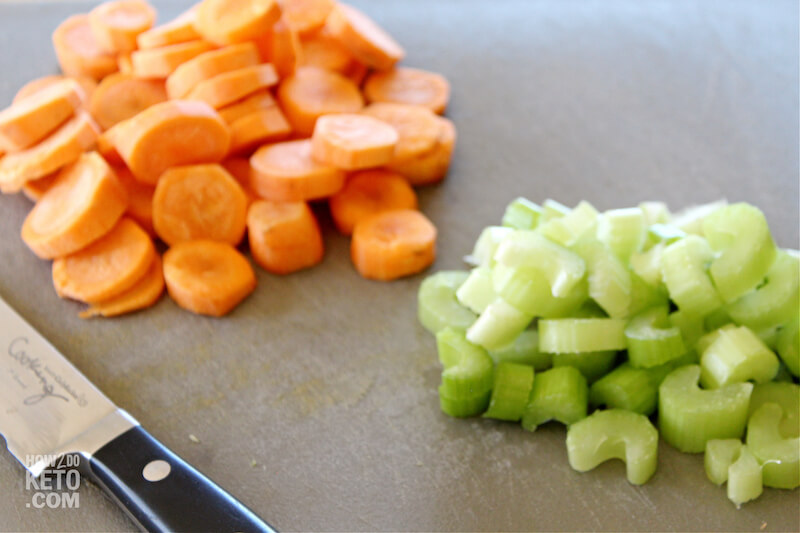 chopped carrots and celery on cutting board