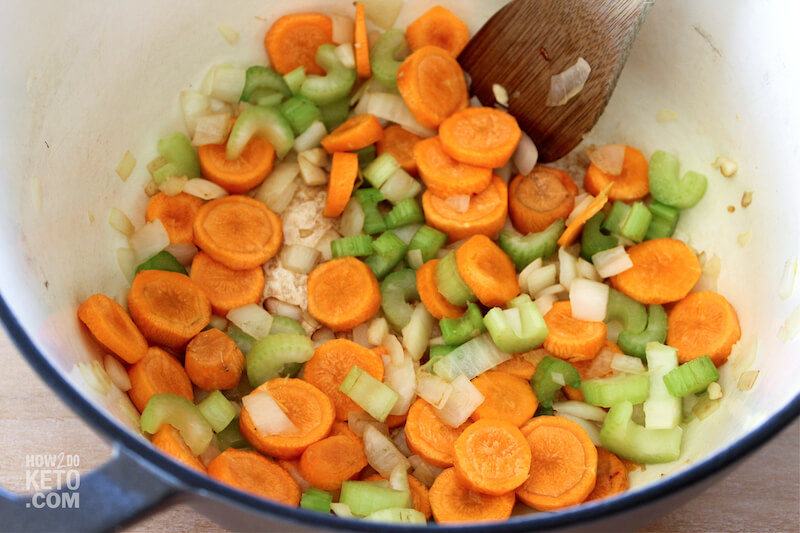 cooking celery, carrots, and onions in soup pot
