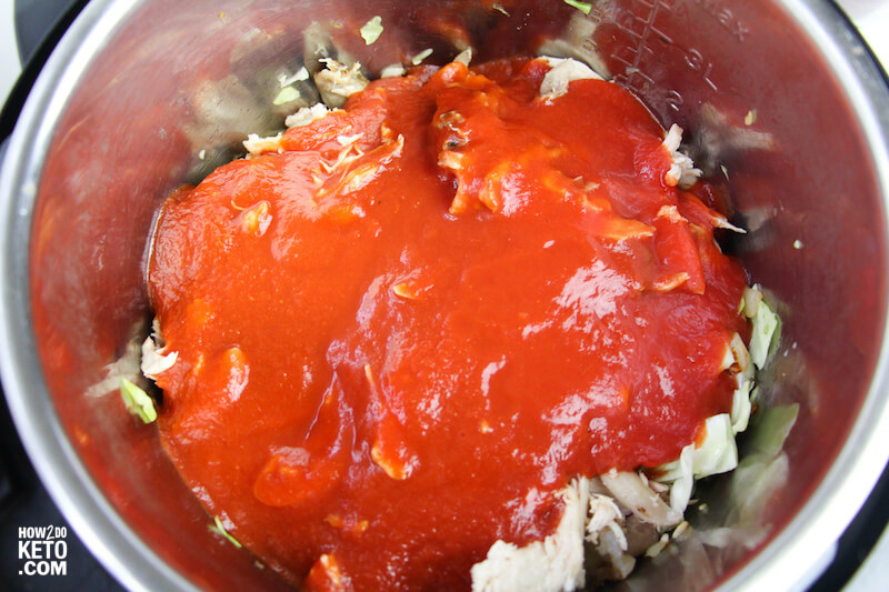 shredded chicken and red enchilada sauce in Instant Pot