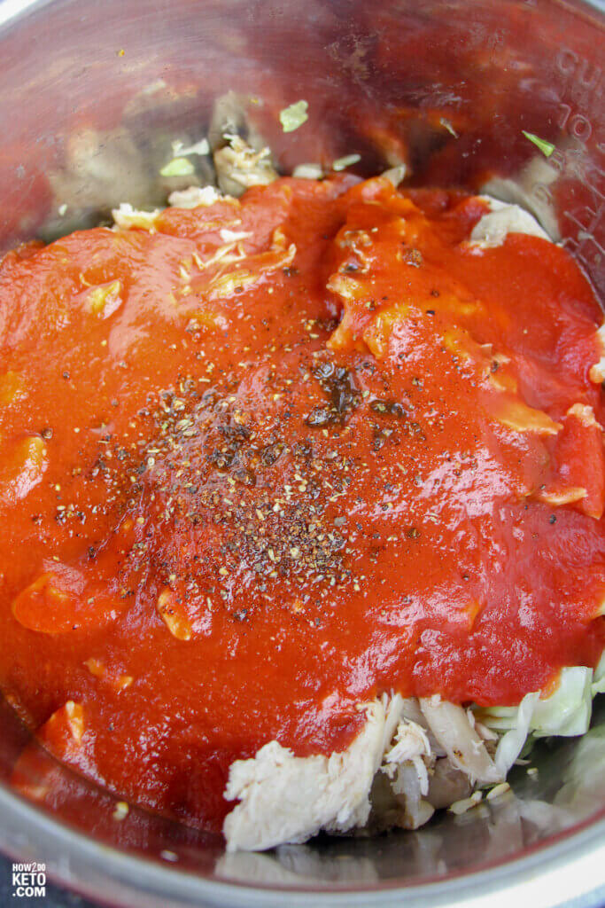 shredded chicken, red enchilada sauce, and seasoning in Instant Pot
