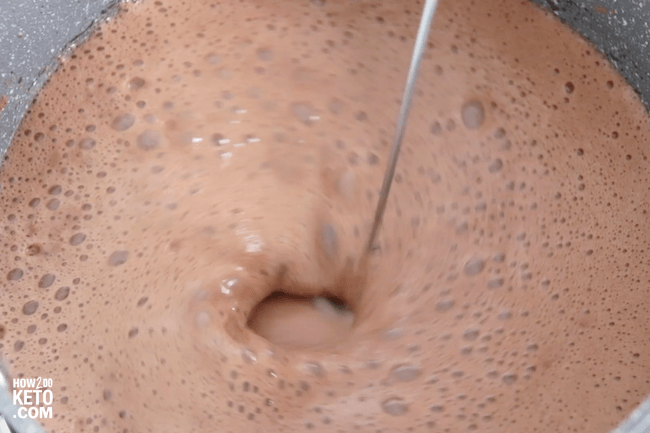 mixing hot chocolate with a milk frother