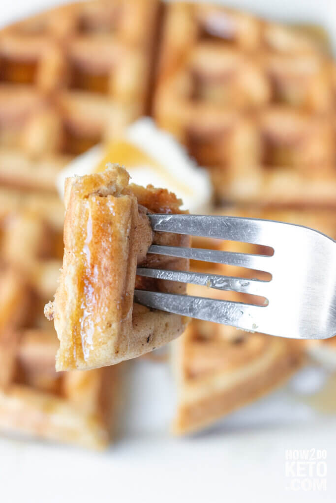 cutting a bite of peanut butter waffle with fork