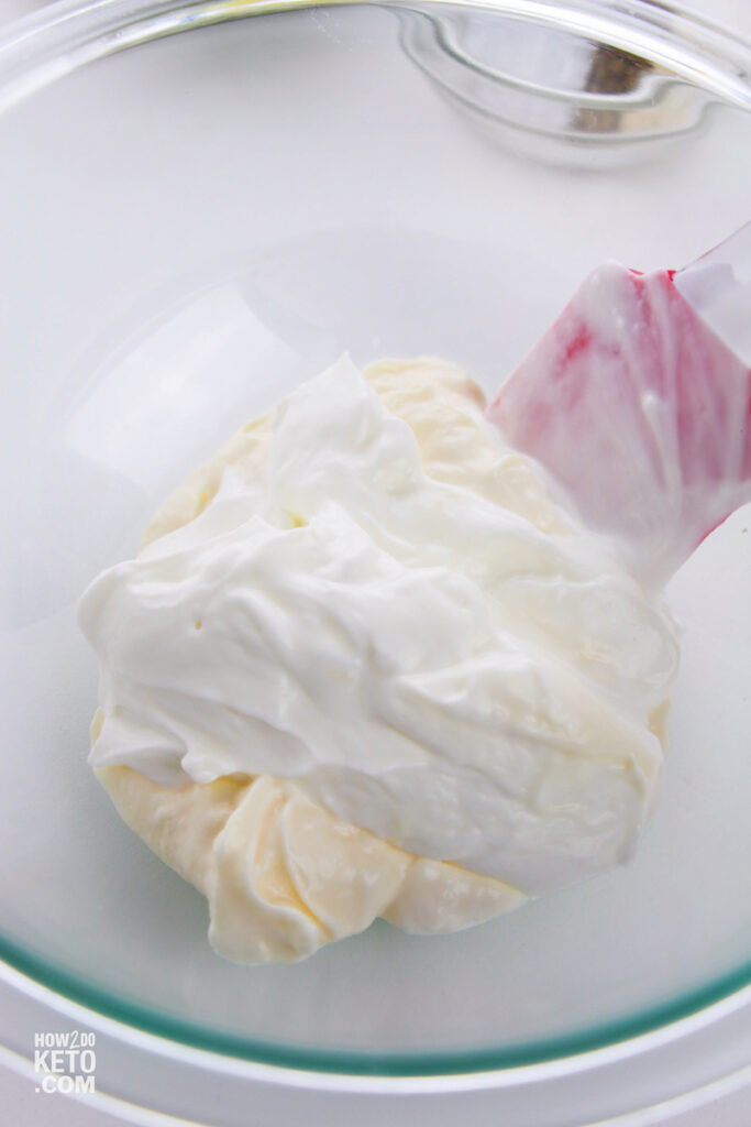 mixing mayonnaise and sour cream in glass bowl