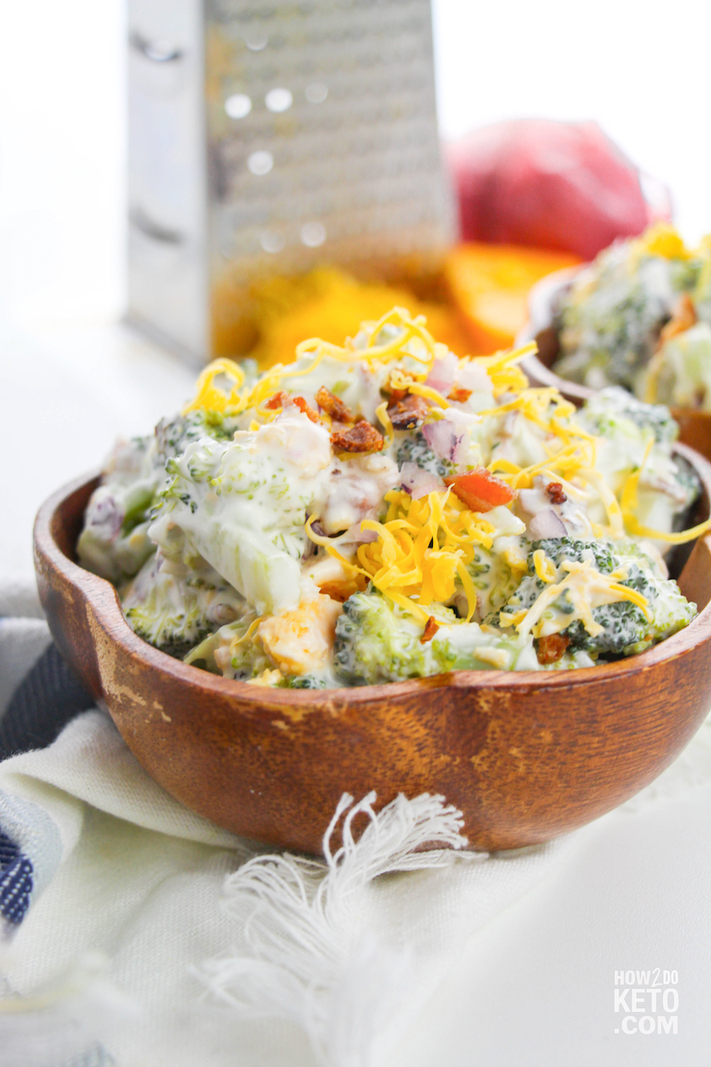 homemade low carb broccoli salad topped with cheddar cheese