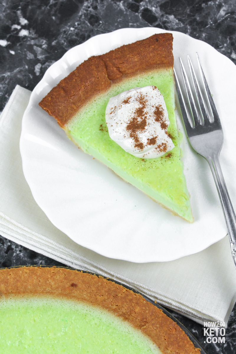 A slice of Keto Key Lime Pie with whipped cream