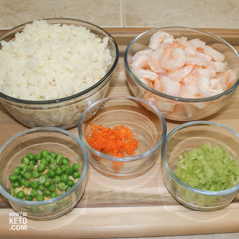 glass bowls containing cauliflower rice ingredients and shrimp