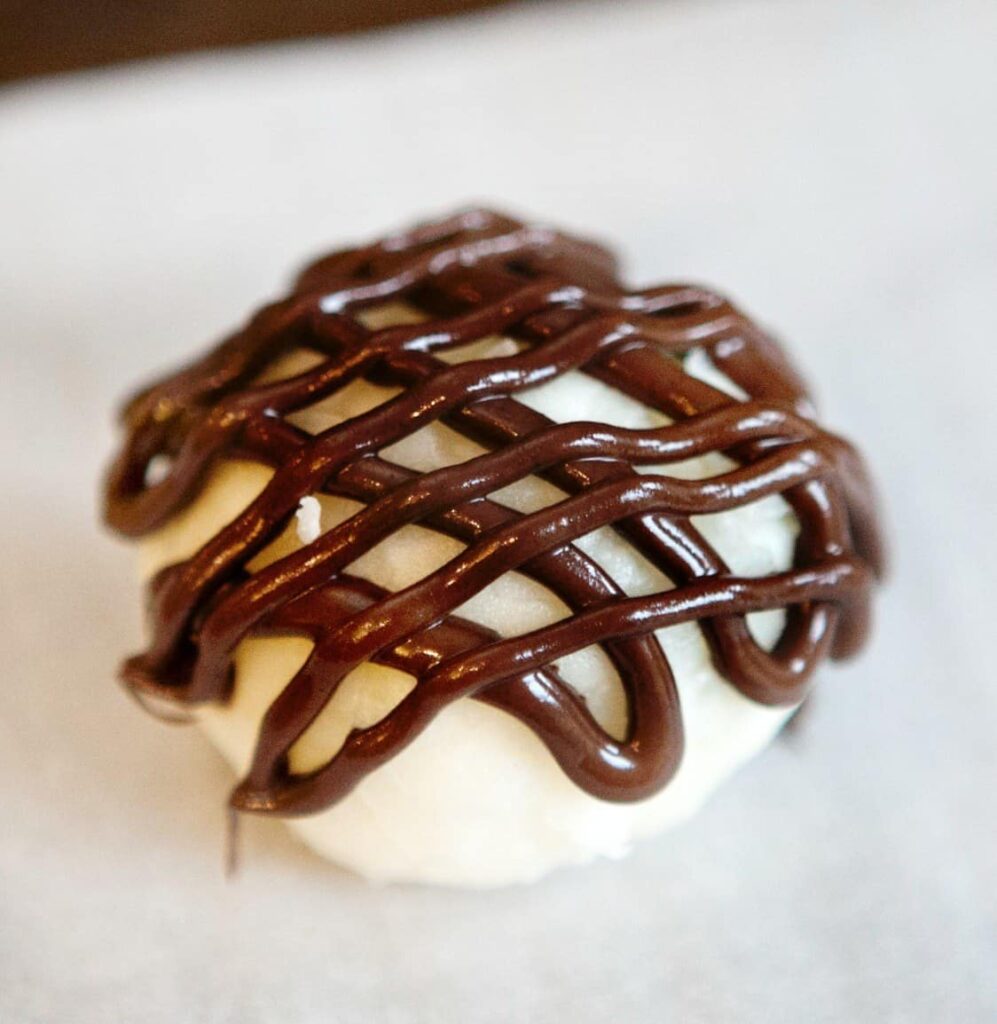 white chocolate fat bomb drizzled with chocolate