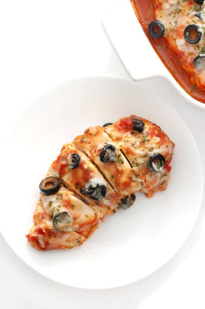 cooked chicken breast with tomato sauce and olives