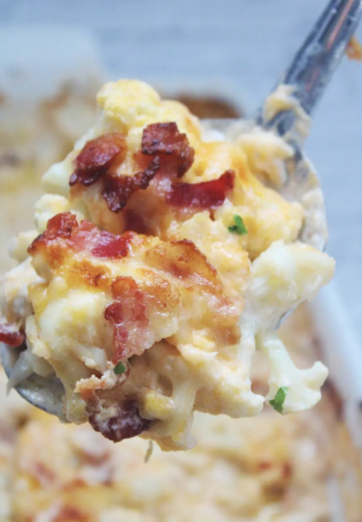 close up of casserole on spoon with chicken, cheese, and bacon