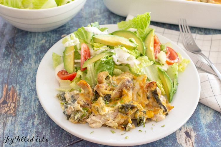 chili relleno casserole on plate with lettuce and avocado slices