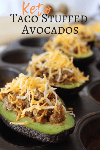 keto stuffed avocados topped with shredded cheese