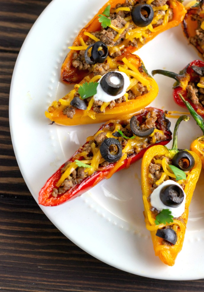 stuffed mini pepper with cheese and olives on top