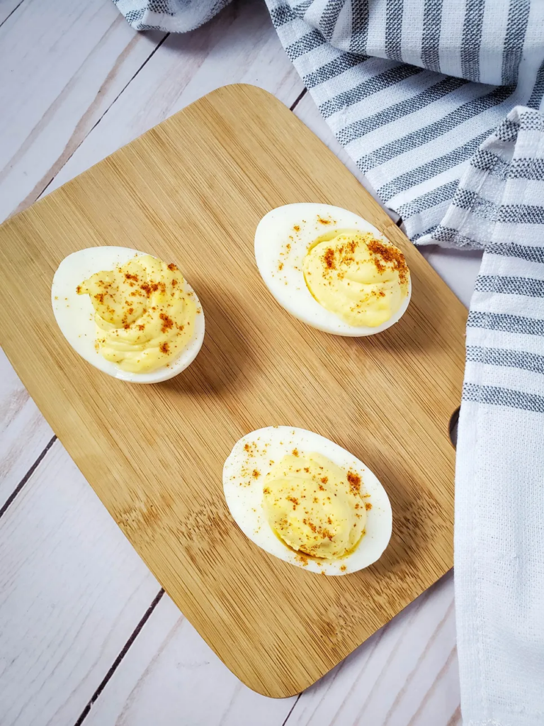 deviled eggs on cutting board