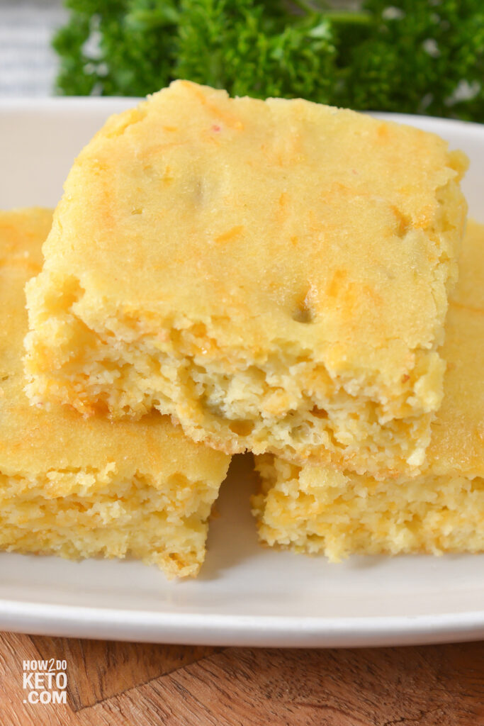 close up of low carb cheesy cornbread on serving plate