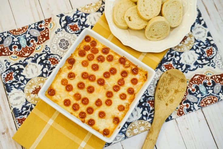 pizza dip in a white dish, topped with pepperoni