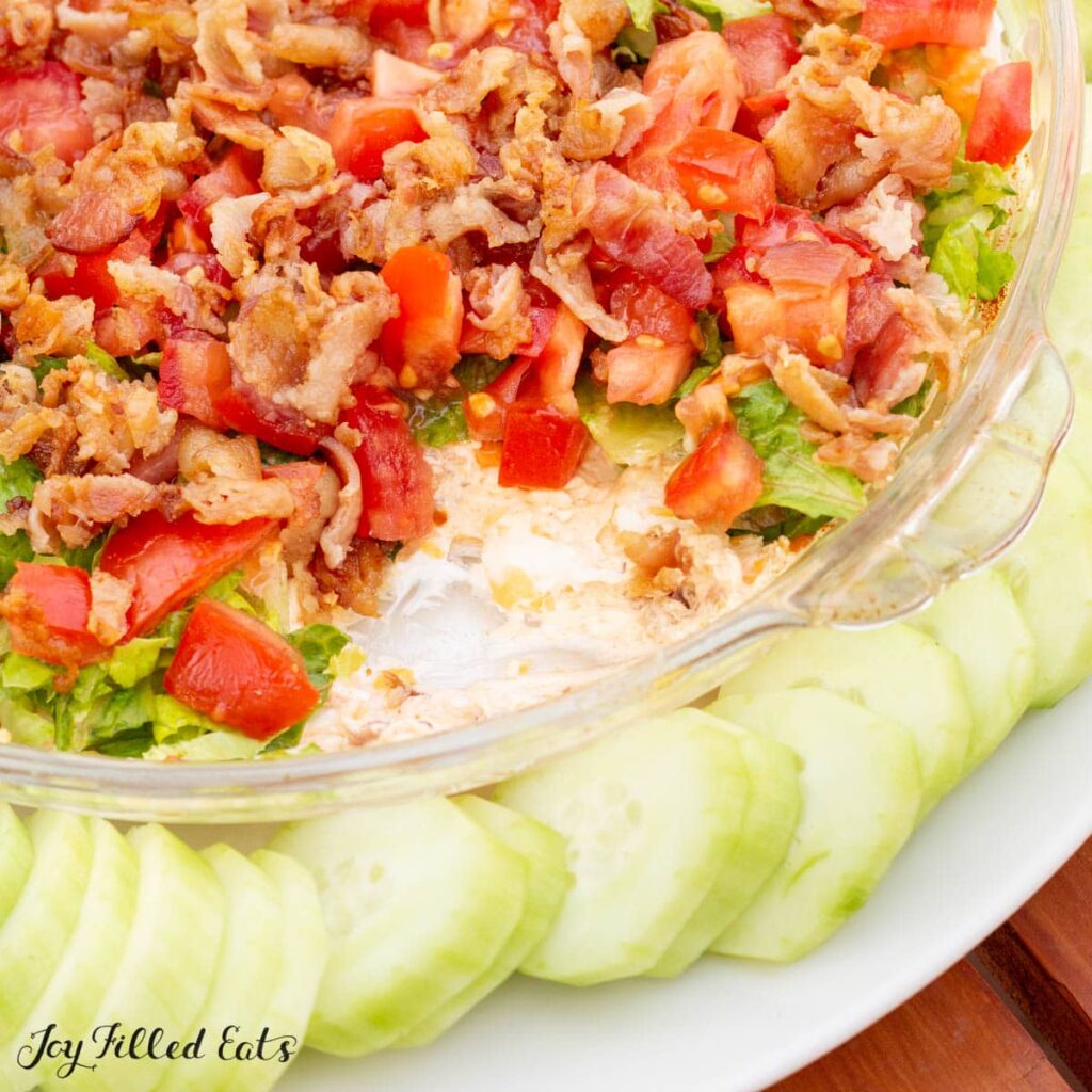 keto blt dip in bowl with cucumber slices